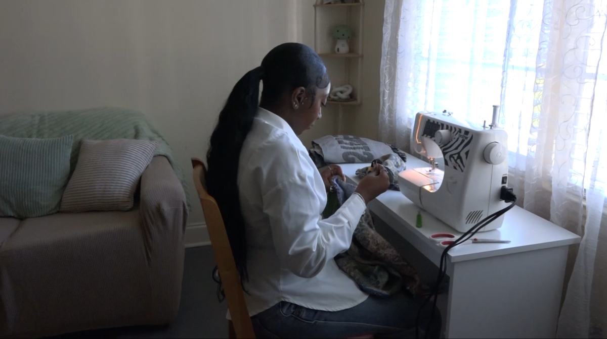 Kambria Dotson works on a custom piece in her apartment.
